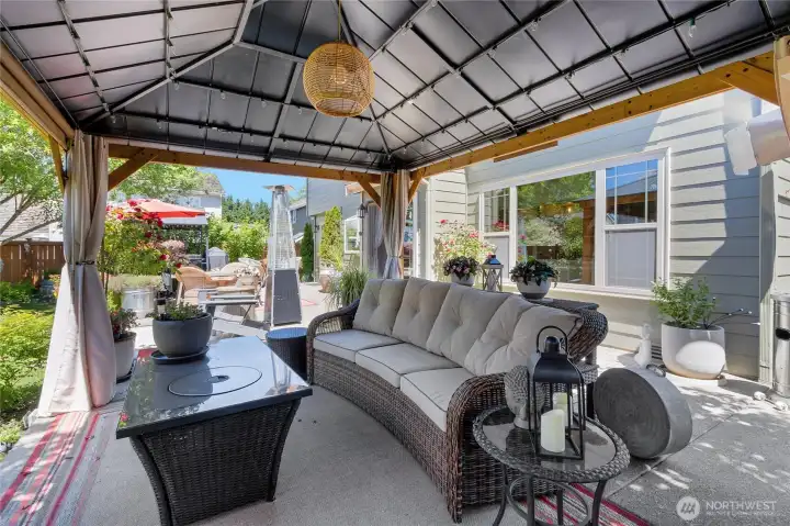 The covered gazebo creates a true outdoor living room, offering a comfortable place to relax, entertain, or enjoy the backyard in every season.