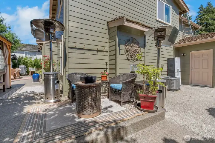 Thoughtfully designed for year-round enjoyment, multiple gathering areas—including heated seating spaces—invite conversation, relaxation, and outdoor entertaining well beyond the summer months.