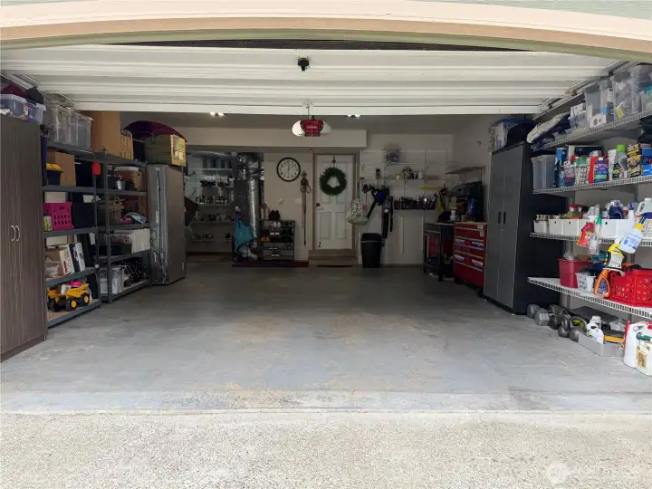 Rare 3-car garage with extensive built-in storage, workspace areas, and room for vehicles, hobbies, and outdoor gear.