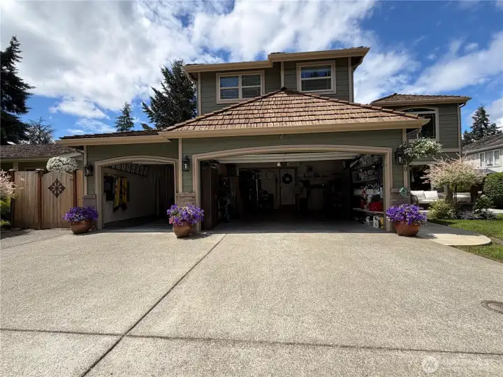 3-car garage offering ample room for vehicles, hobbies, storage, and organization, complete with built-in shelving and dedicated workspace areas.