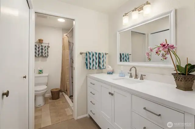 Updated, compartmentalized primary bath has walk-in shower.