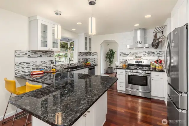 Updated kitchen provides expansive granite countertops for relaxed meals and extra prep space for the cook.