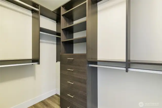Primary bedroom has a walk in closet with custom closet system