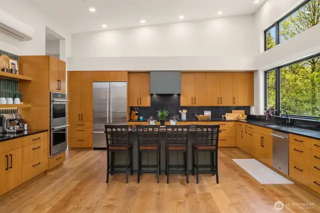 Every bit of this kitchen was thoughtfully designed with a chef in mind! Custom-built alder cabinets with an abundance of drawers for easy storage, quality Jenn-Air appliances, 42" French door refrigeratoer, 30' double ovens with convection, quartz counter tops, large coffee bar with open shelving and sink with water filtration system. It's a dream!