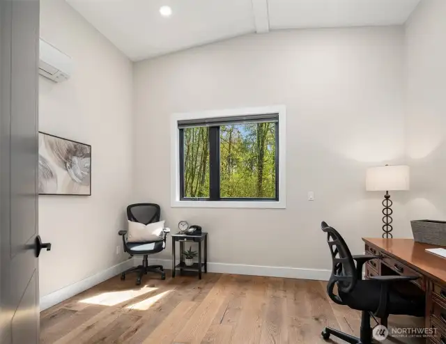 Office with hardwood floors adjacent to the Primary suite.