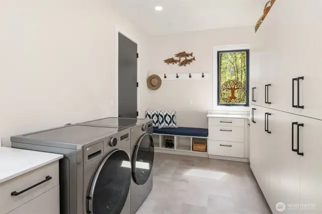Laundry room/mud room space with access to the garage.  So much storage!!!