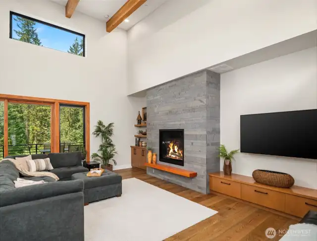 Living Room with 42" propane fireplace with stone surround. (Remote operated) Built-in open shelves and storage cabinets. TV is installed on a swivel mount for easy viewing and all wiring is built into the wall.