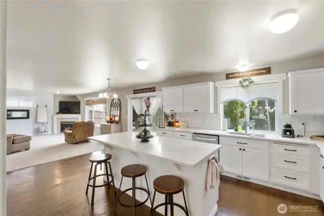 Spacious Kitchen with Island featuring Quartz Counter Tops, Engineered Hardwood Floors, refaced cabinets and Stainless steel appliances!