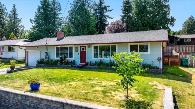 Front yard with flower beds along the front of the home.