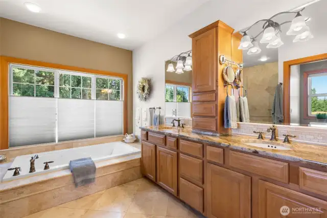 Spa like primary ensuite bath with double vanity, jetted tub and heated floors.