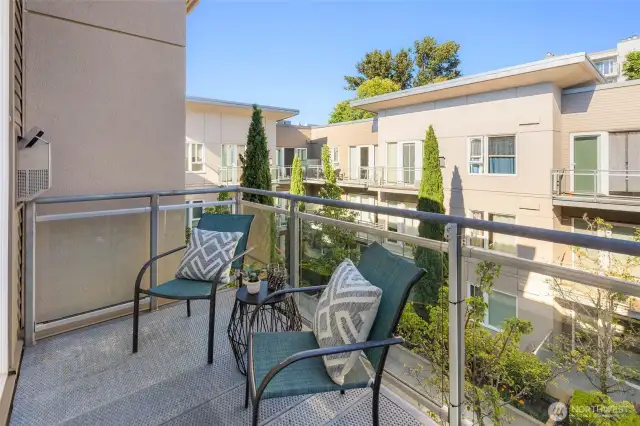 Balcony overlooks the manicured courtyard below.