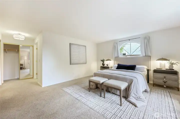 Closets lead to the en suite bath.