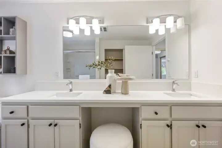 Double sinks and seating, plus a linen closet.