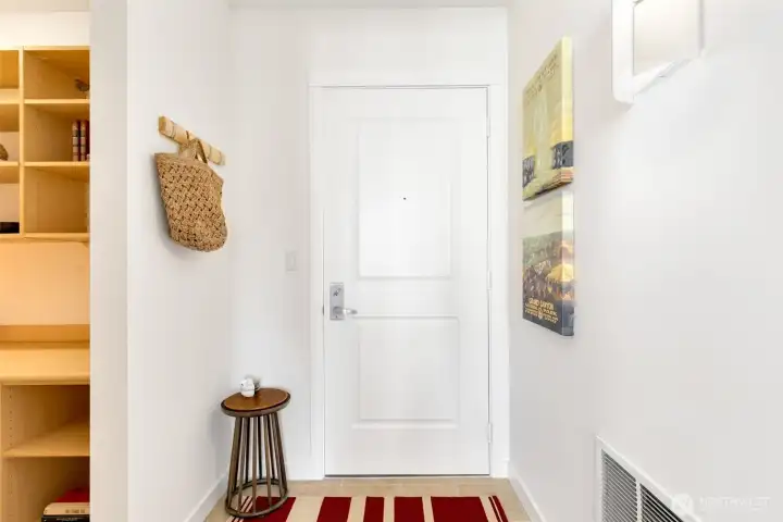 The entry hall has space for hanging and an entry table or shelving.