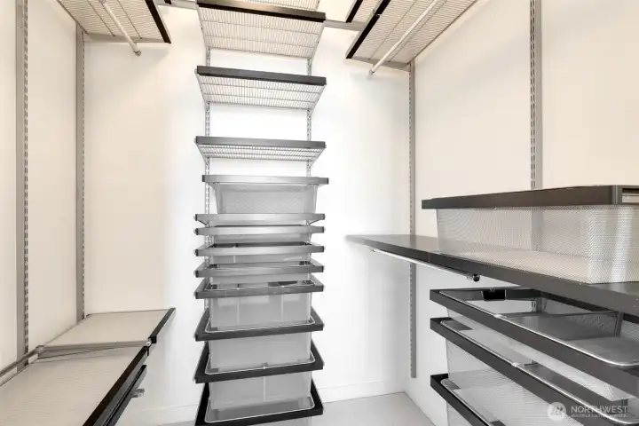 This closet has a customizable organizational system from the container store- shelves, drawers, and bins can be moved around and adjusted as desired.