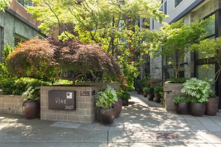 The entrance to the Vine complex features lush landscaping to welcome you home or greet your guests.