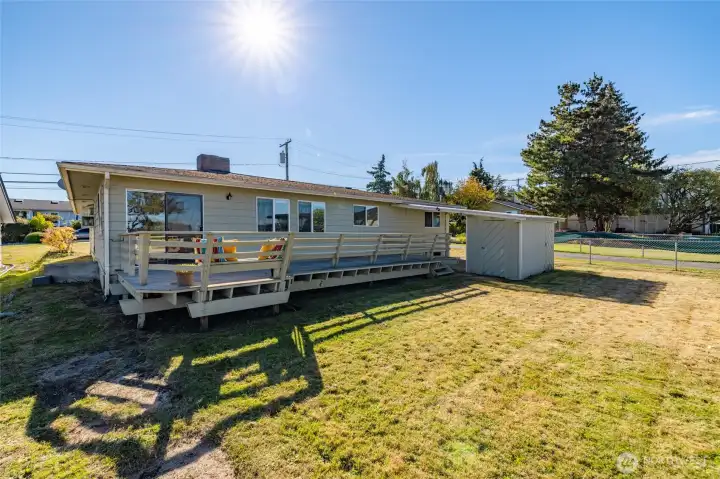 The spacious back yard has a large hardwood deck, an extra carport and storage area and plenty of room for gardening or yard games.