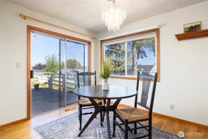 Dining area looking out over the hardwood deck and large back yard with peek boo views of the water and mountains.