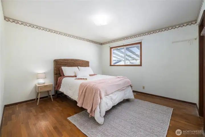 Primary bedroom with a walk in closet and attached 3/4 bath.