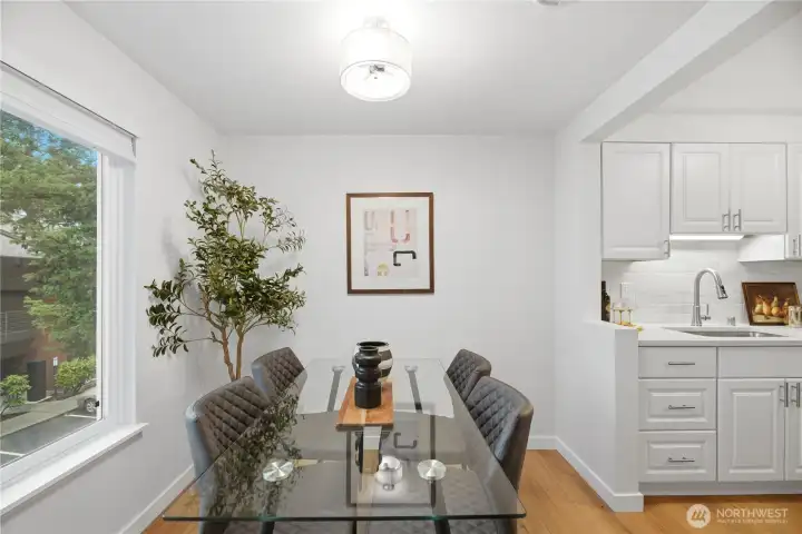 Dining room highlighted by a new designer light fixture, perfect for everyday dining or entertaining.