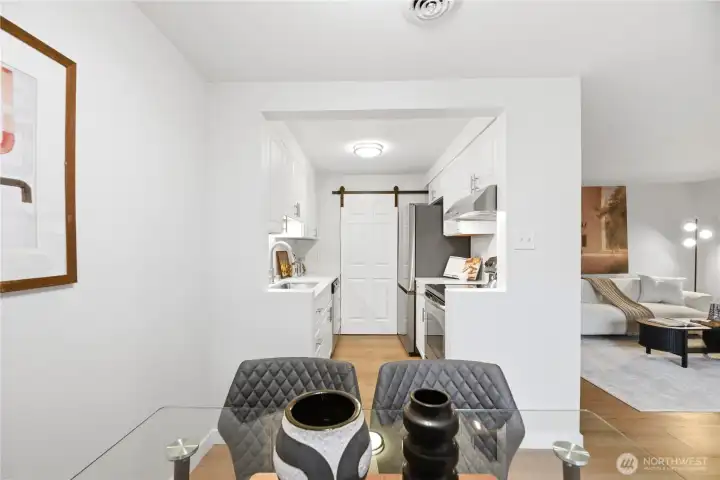 The galley kitchen entry has been creatively opened to improve flow and provide a brighter, more open and spacious feel.