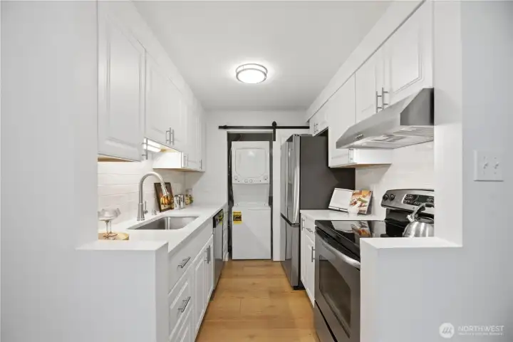 The galley kitchen entry has been creatively opened to improve flow and provide a brighter, more open and spacious feel.