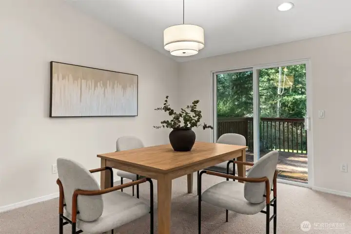 The seamless transition from the kitchen to the outdoor deck creates a fluid social environment, perfect for hosting dinners or outdoor gatherings.