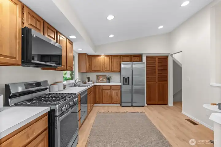 This layout offers a refreshing sense of scale. By prioritizing wide-open floor space, the kitchen feels exceptionally airy, highlighting the seamless run of custom woodwork and the sophisticated, durable countertops.