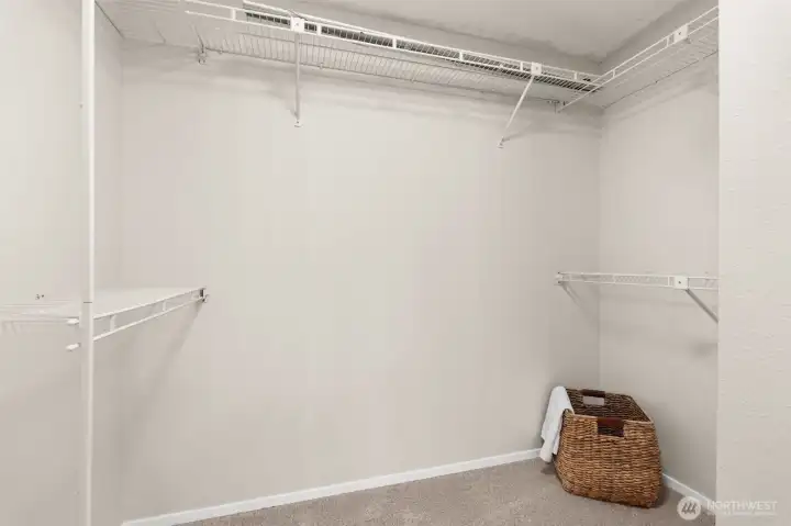 Enjoy this primary suite's walk-in closet, fitted with organizational shelving and refined for spatial harmony.