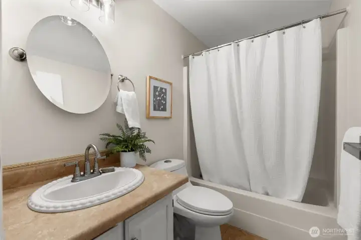 A sophisticated shared bath that prioritizes artisanal detail.