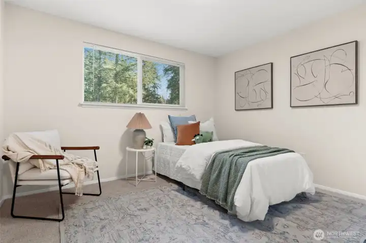 A bright and airy third bedroom that showcases the home’s incredible versatility. Currently staged as a playful retreat, the room’s generous proportions and clean lines make it an ideal canvas for any residential need.