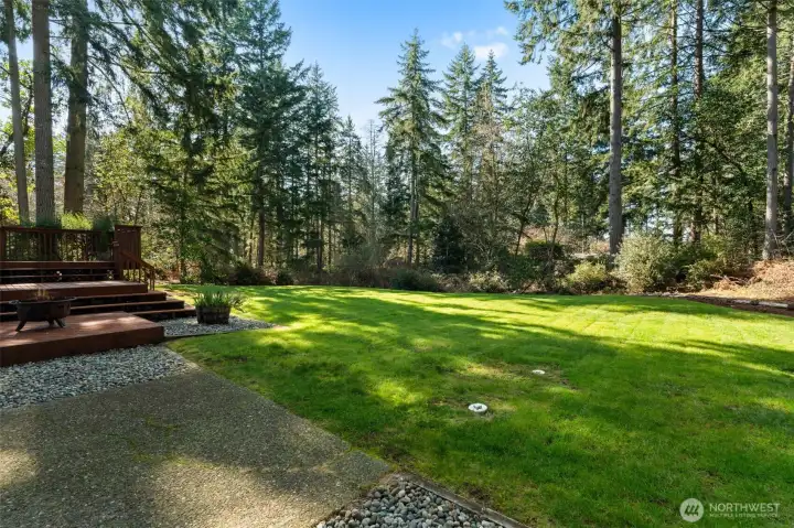 A lush, expansive emerald lawn serves as the centerpiece of this private outdoor retreat. It’s a rare stretch of level green space that offers a sense of park-like serenity right in your own backyard.