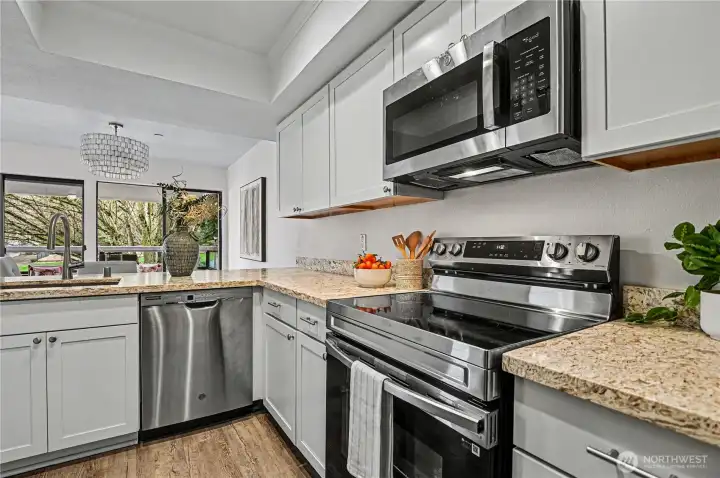 A bright and functional kitchen designed for both style and convenience, featuring a pass through to the dining and living room.