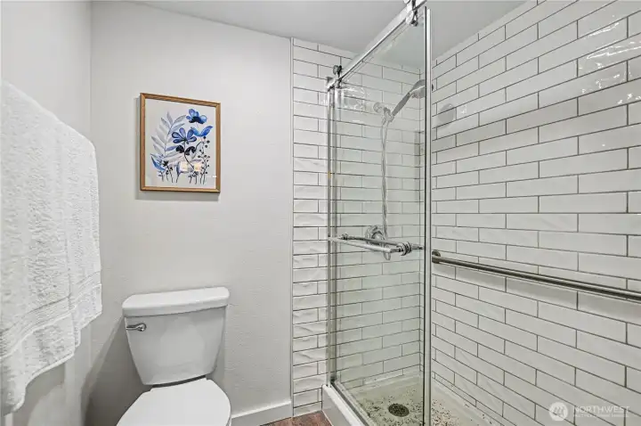 Primary en-suite with toilet and shower conveniently tucked away.