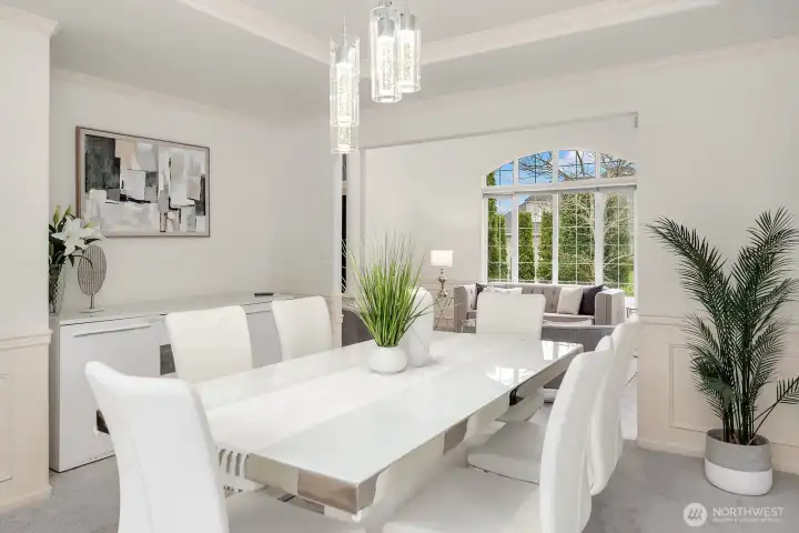 Bathed in natural light from oversized windows, this gracious dining room offers ample space for entertaining, with refined details and a seamless connection to the main living areas.