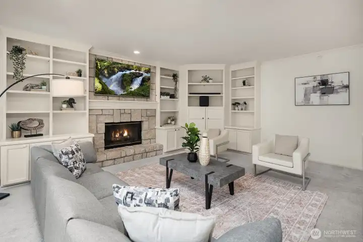 A warm and inviting family room showcases custom built-ins, a classic fireplace, and an abundance of natural light, creating the ultimate space to relax and unwind.