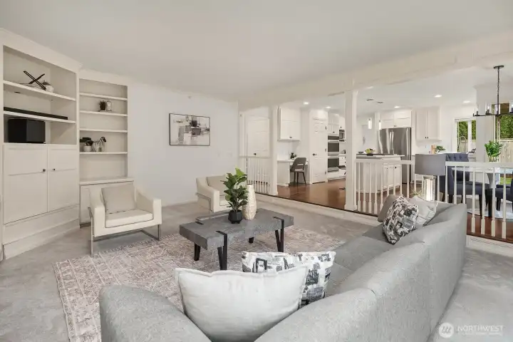 The family room flows effortlessly into the chef's kitchen beyond, offering an ideal open-concept layout perfect for both everyday living and entertaining guests.