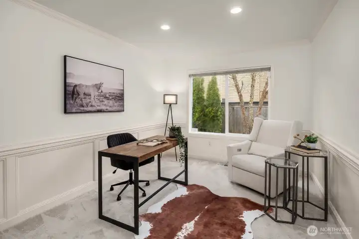 The dedicated main level office offers a quiet, light-filled workspace with a large window and flexible layout, easily convertible to a 5th bedroom to suit your needs.