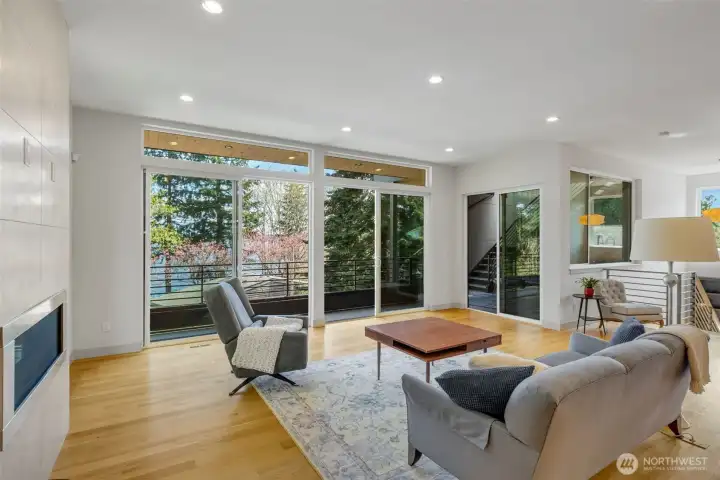 Walls of glass open to a covered balcony, which leads to the roof deck.
