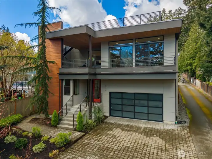 An oversized attached garage with plenty of driveway parking. Plus, a dedicated off-street spot in front (out of frame).