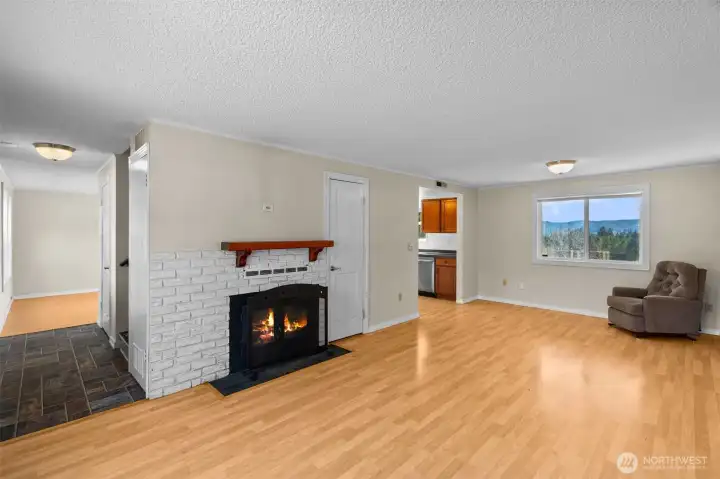 Inside is bright and airy with newer paint and a cozy wood-burning fireplace.