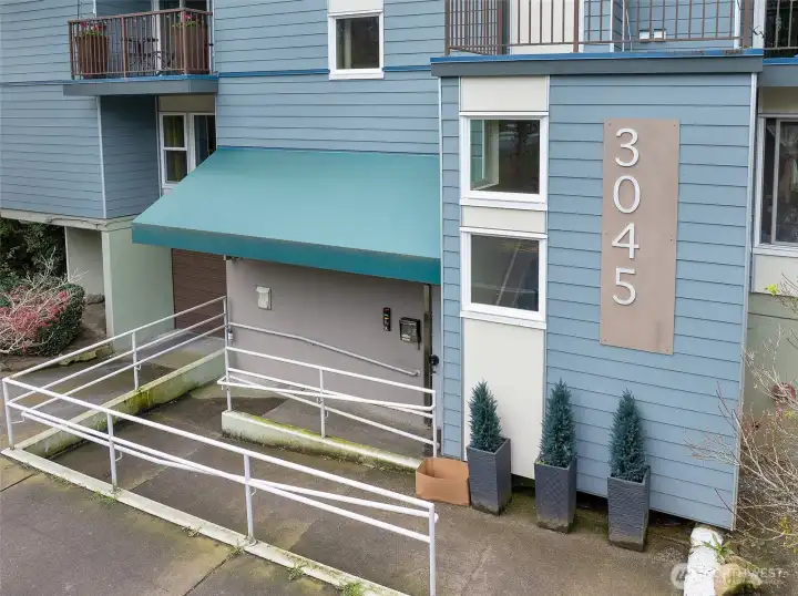 Street level ramp leading to secure lobby entrance with step free access