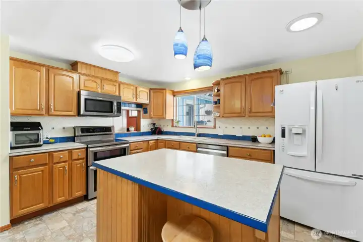 Kitchen with kick sweep to vacuum and peek through to bonus room.