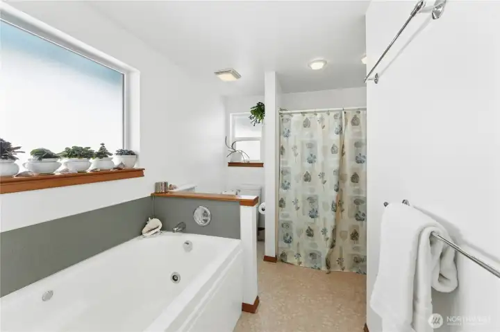 Primary bathroom with jetted tub and walk in shower.
