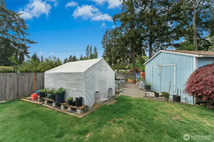 Garden space with raised and walk up beds. Greenhouse conveys