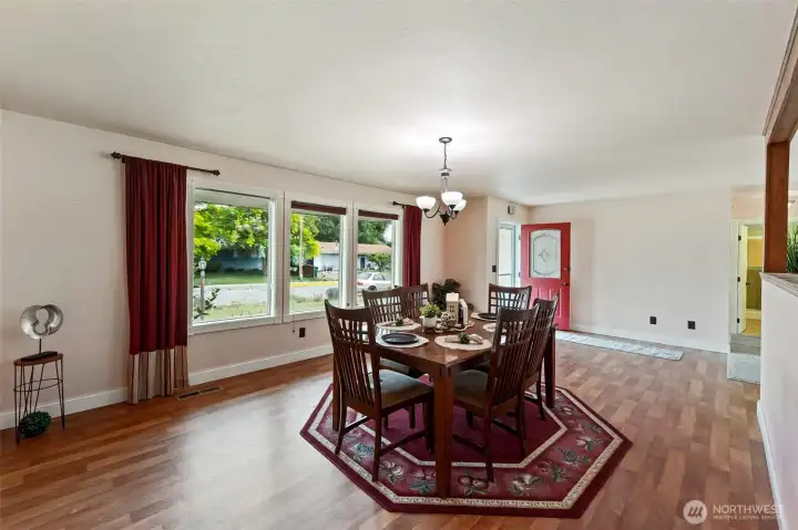 Inviting dining are with wall of windows and blinds