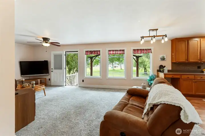 door with built in blind and screen door leads to deck- the park is your back drop