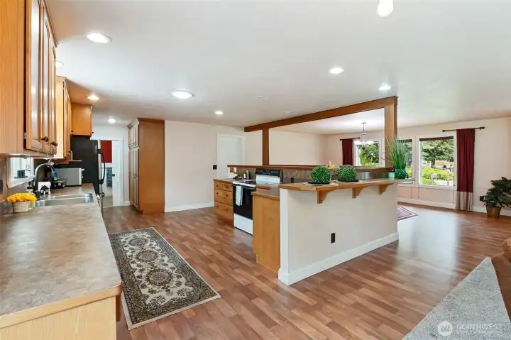 A large kitchen with built in pantry and bar seating