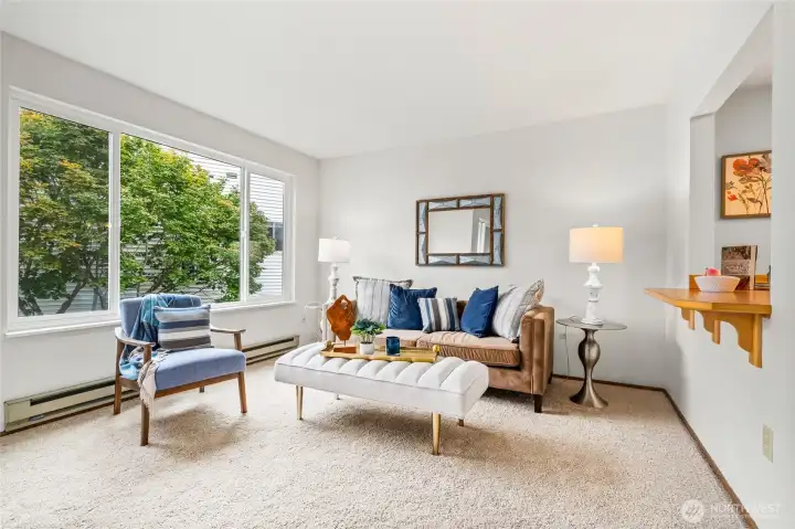 Spacious family room with natural lighting, new carpet, new coat of paint throughout.