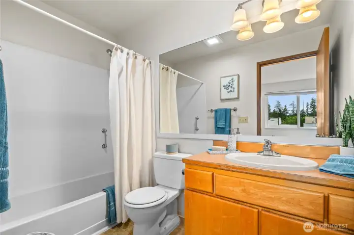 Primary Bathroom with updated lighting, molding, painting and towel rack.
